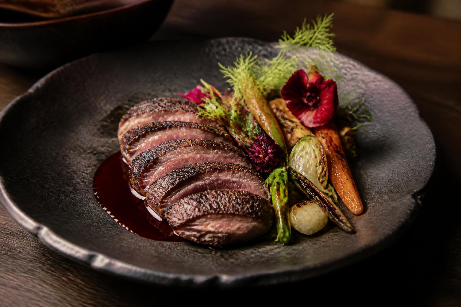 Smoked jerk duck with seasonal vegetables